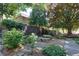 Secluded courtyard with stone table and benches surrounded by lush landscaping and fencing at 301 Lakemoore Ne Dr # B, Atlanta, GA 30342