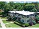 View of a two-story apartment building with lush landscaping and sidewalks at 301 Lakemoore Ne Dr # B, Atlanta, GA 30342