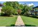 Beautifully maintained grounds with a walkway leading through lush green lawns and mature trees at 301 Lakemoore Ne Dr # B, Atlanta, GA 30342