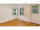 Bright living room featuring parquet floors, a window with shutters, and a door to the outside at 301 Lakemoore Ne Dr # B, Atlanta, GA 30342