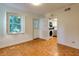 Bright living room featuring parquet floors, a window with shutters, and a door to the outside at 301 Lakemoore Ne Dr # B, Atlanta, GA 30342