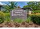 Community signage for Lakemoore Colony, a private townhome community, with landscaping at 301 Lakemoore Ne Dr # B, Atlanta, GA 30342