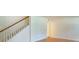 Staircase next to a spacious room with wooden floors and cream walls at 301 Lakemoore Ne Dr # B, Atlanta, GA 30342