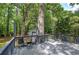 Back deck with ample seating overlooking a lush yard and a detached garage at 3710 Lavilla Dr, Powder Springs, GA 30127