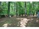 Large, grassy backyard enclosed by a wooden privacy fence and mature trees at 3710 Lavilla Dr, Powder Springs, GA 30127