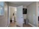 Cozy half bathroom featuring wood-style flooring and neutral paint, adjacent to the bedroom at 3710 Lavilla Dr, Powder Springs, GA 30127