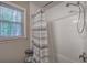 Bathroom with a shower featuring a decorative shower curtain and a window with privacy blinds at 3710 Lavilla Dr, Powder Springs, GA 30127