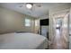 Bedroom featuring wood-style floors, a ceiling fan, and a wall-mounted television at 3710 Lavilla Dr, Powder Springs, GA 30127