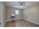 Bedroom features wood-style floors, neutral paint, a ceiling fan, and a vanity table at 3710 Lavilla Dr, Powder Springs, GA 30127
