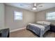 Bedroom featuring wood-style floors, neutral paint, and natural light from two windows at 3710 Lavilla Dr, Powder Springs, GA 30127