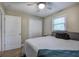 Inviting bedroom with neutral walls, a ceiling fan, double closet, and plush bedding at 3710 Lavilla Dr, Powder Springs, GA 30127