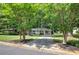 Charming single-story home with a covered front porch and beautifully landscaped front yard at 3710 Lavilla Dr, Powder Springs, GA 30127
