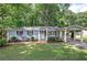 Charming single-story home with a welcoming front yard and a covered carport at 3710 Lavilla Dr, Powder Springs, GA 30127