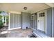 Covered front porch entrance featuring a brick pillar and a light gray painted exterior at 3710 Lavilla Dr, Powder Springs, GA 30127