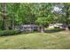 Charming single-story home with a well-manicured lawn and mature trees at 3710 Lavilla Dr, Powder Springs, GA 30127