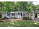 Beautifully landscaped front yard with charming single-story home and stylish carport at 3710 Lavilla Dr, Powder Springs, GA 30127