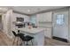 Bright kitchen features white cabinets, stainless appliances, granite counters, and a functional center island at 3710 Lavilla Dr, Powder Springs, GA 30127