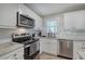 Modern kitchen featuring granite countertops, stainless steel appliances, and white subway tile backsplash at 3710 Lavilla Dr, Powder Springs, GA 30127