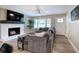 Comfortable living room with fireplace and large windows at 3710 Lavilla Dr, Powder Springs, GA 30127