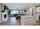 An open living space with a brick fireplace, large window, and a convenient kitchen island at 3710 Lavilla Dr, Powder Springs, GA 30127