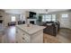 Open-concept living space featuring a fireplace, large window, modern ceiling fan and kitchen island at 3710 Lavilla Dr, Powder Springs, GA 30127