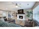 Cozy living room features a white-painted brick fireplace and a ceiling fan at 3710 Lavilla Dr, Powder Springs, GA 30127