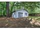 View of the detached two-car garage with gray painted siding in fenced backyard at 3710 Lavilla Dr, Powder Springs, GA 30127