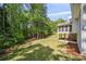 Expansive backyard featuring a screened porch and mature trees providing shade and privacy at 4585 Lakefield Bnd, Berkeley Lake, GA 30096
