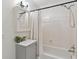 Cozy bathroom with shower-tub combo, modern vanity, and neutral decor at 4585 Lakefield Bnd, Berkeley Lake, GA 30096