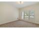 Neutral bedroom featuring natural light, plush carpet, and versatile space at 4585 Lakefield Bnd, Berkeley Lake, GA 30096