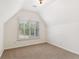 Bedroom featuring neutral carpet, white walls, and a window at 4585 Lakefield Bnd, Berkeley Lake, GA 30096