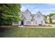 Stately two-story home boasting manicured lawn and elegant architectural details at 4585 Lakefield Bnd, Berkeley Lake, GA 30096