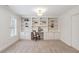 Home office featuring built-in shelving, a large window with plantation shutters, and plush carpet at 4585 Lakefield Bnd, Berkeley Lake, GA 30096