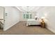 Spacious main bedroom featuring a tray ceiling, plush carpet, and bright window views at 4585 Lakefield Bnd, Berkeley Lake, GA 30096