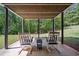 Covered patio with rocking chairs overlooking lush backyard at 4585 Lakefield Bnd, Berkeley Lake, GA 30096