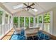 Bright sunroom boasts natural light, comfortable seating, and serene views of the wooded backyard at 4585 Lakefield Bnd, Berkeley Lake, GA 30096