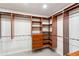Custom walk-in closet with wood shelving, built-in drawers, and ample storage space at 4585 Lakefield Bnd, Berkeley Lake, GA 30096
