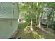Serene backyard offers a lush green lawn, mature trees, and space for outdoor activities at 4739 Bradford Ln, Powder Springs, GA 30127