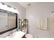 Well-lit bathroom with a large mirror, a modern vanity, and white tile at 4739 Bradford Ln, Powder Springs, GA 30127