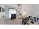 Bedroom with plush carpeting, natural light, and modern furnishings at 4739 Bradford Ln, Powder Springs, GA 30127