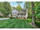 Beautifully landscaped front yard showcases a well-maintained two-story home with a charming front porch at 4739 Bradford Ln, Powder Springs, GA 30127
