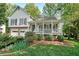 Charming two-story home featuring a welcoming front porch, manicured lawn, and an attached two-car garage at 4739 Bradford Ln, Powder Springs, GA 30127