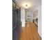 Bright foyer featuring gleaming hardwood floors, a stylish front door, and views into the living spaces at 4739 Bradford Ln, Powder Springs, GA 30127