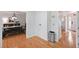 Hallway with wood floors that opens to dining room and front entrance at 4739 Bradford Ln, Powder Springs, GA 30127
