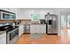 Classic kitchen with white cabinets, granite countertops, and stainless steel appliances at 4739 Bradford Ln, Powder Springs, GA 30127