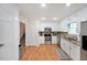 Well-lit kitchen with white cabinets, stainless steel appliances, and wood floors for a modern look at 4739 Bradford Ln, Powder Springs, GA 30127