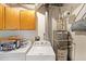 Functional laundry room with a washing machine, dryer, storage cabinets, and modern appliances at 4739 Bradford Ln, Powder Springs, GA 30127