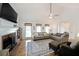 Inviting living room featuring a brick fireplace, high ceilings, and large windows for ample natural light at 4739 Bradford Ln, Powder Springs, GA 30127