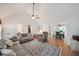 Open-concept living room with hardwood floors connecting to a dining area, perfect for entertaining at 4739 Bradford Ln, Powder Springs, GA 30127