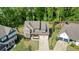 Beautiful aerial view of home with manicured lawn and a three-car garage at 242 Fieldbrook Xing, Canton, GA 30115